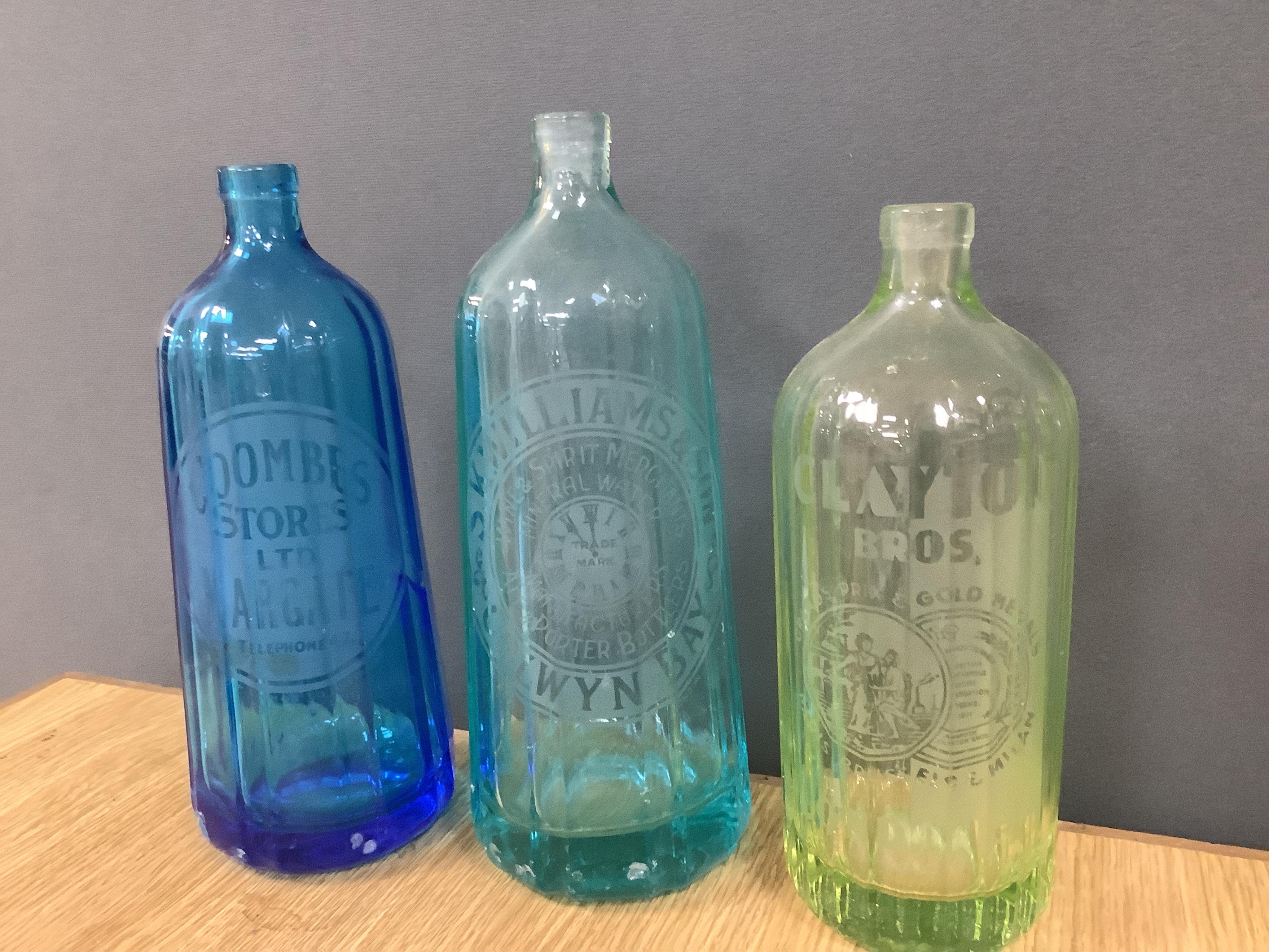 An Edwardian Standard English Seltzogenes double gourd Soda Syphon, one other and a collection of coloured glass bottles. Condition - varies